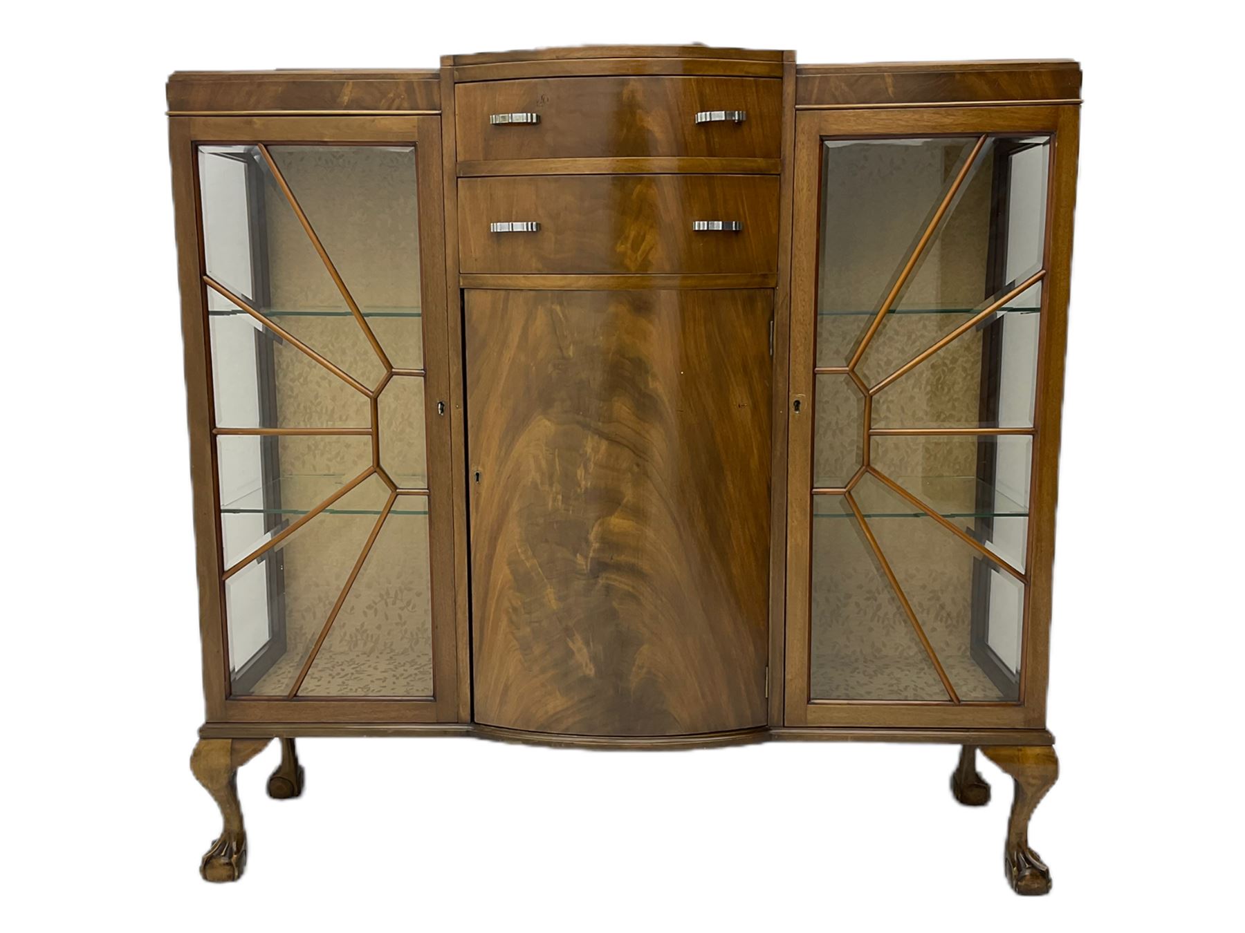 Mid-20th century Art Deco style walnut display cabinet, two central drawers over cupboard flanked by two bevel glazed display cabinets with sunburst astragal glazing, on ball and claw cabriole feet