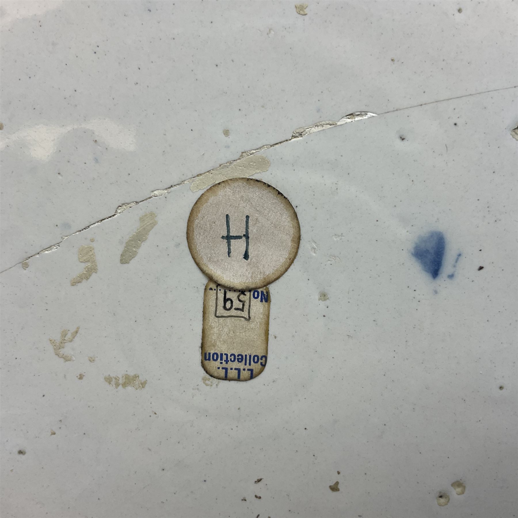 Early 18th century Delft marriage plate, of circular form with dished centre, the centre inscribed and dated 'Thomas and Elizabeth Kockerill Bridlington Key 1715' within a crowned C scroll cartouche, flanked by demi-griffins, above a putto head and tassels, within a wide foliate border, D34cm
