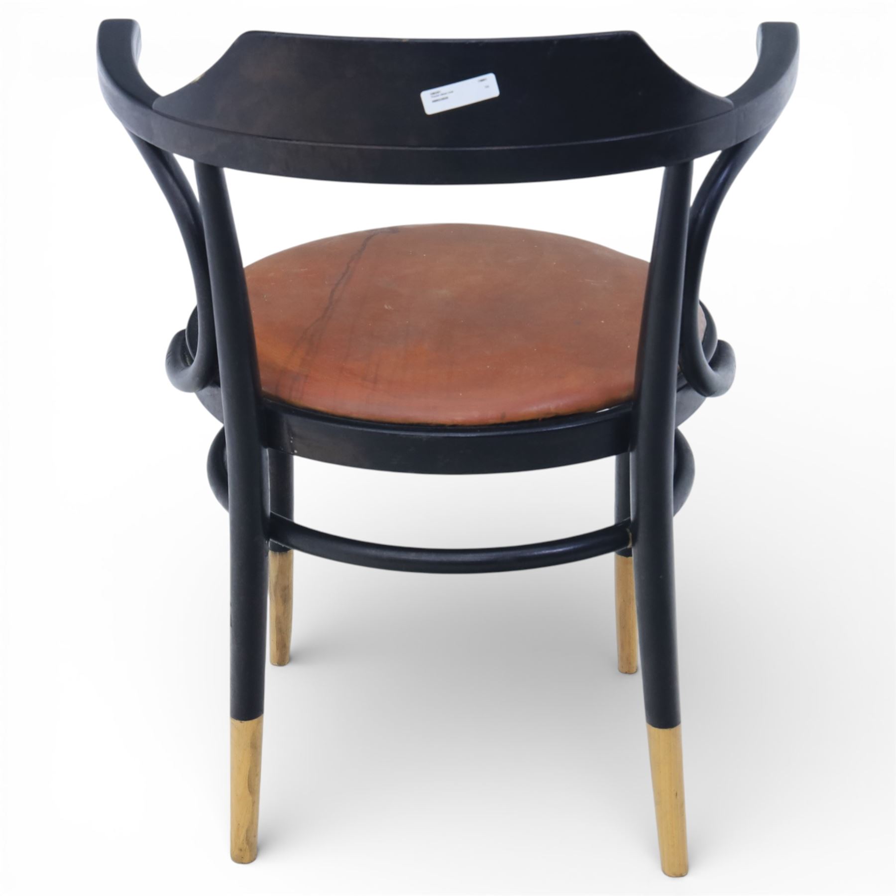 Thonet - 20th century ebonised elbow chair, bentwood construction with a circular brown leather seat, tapering legs with exposed wood supports