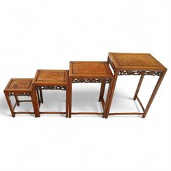 Early 20th century Chinese style hardwood quartetto nest of tables, each with panelled top and carved and pierced vine motif frieze, on square legs united by straight stretchers