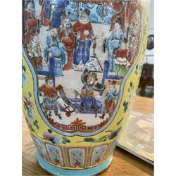 19th century Chinese famille rose yellow ground porcelain vase, of baluster form with twin applied mask ring handles, the body decorated with two shaped reserves mounted with dragon heads, depicting warriors at battle and at court, the neck with two smaller conforming figural reserves, upon a yellow ground decorated with exotic birds amidst scrolling blossom, H45.cm