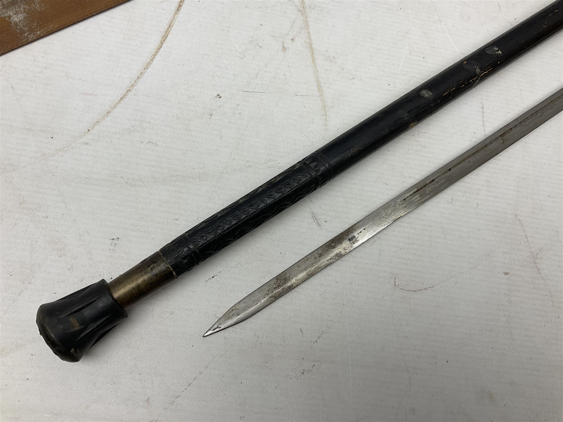 Early 20th century Indian ebonised sword stick, the 59.5cm blade with punched decoration and horn grip L94cm overall; and a reproduction Indian tulwar with scabbard (2)