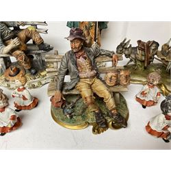 Group of Capodimonte figures, to include musical organ grinder with donkey and monkey, two tramp figures on benches, man with gun and choir boy and girl figures