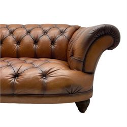 Tetrad - 'Oskar' grande three-seat sofa, Chesterfield shape with rolled arms, upholstered in buttoned tan leather, on turned and reed moulded feet 