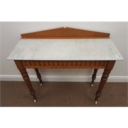  Late Victorian golden oak marble top washstand, shaped raised back, carved frieze, turned supports, W92cm, H87cm, D35cm  