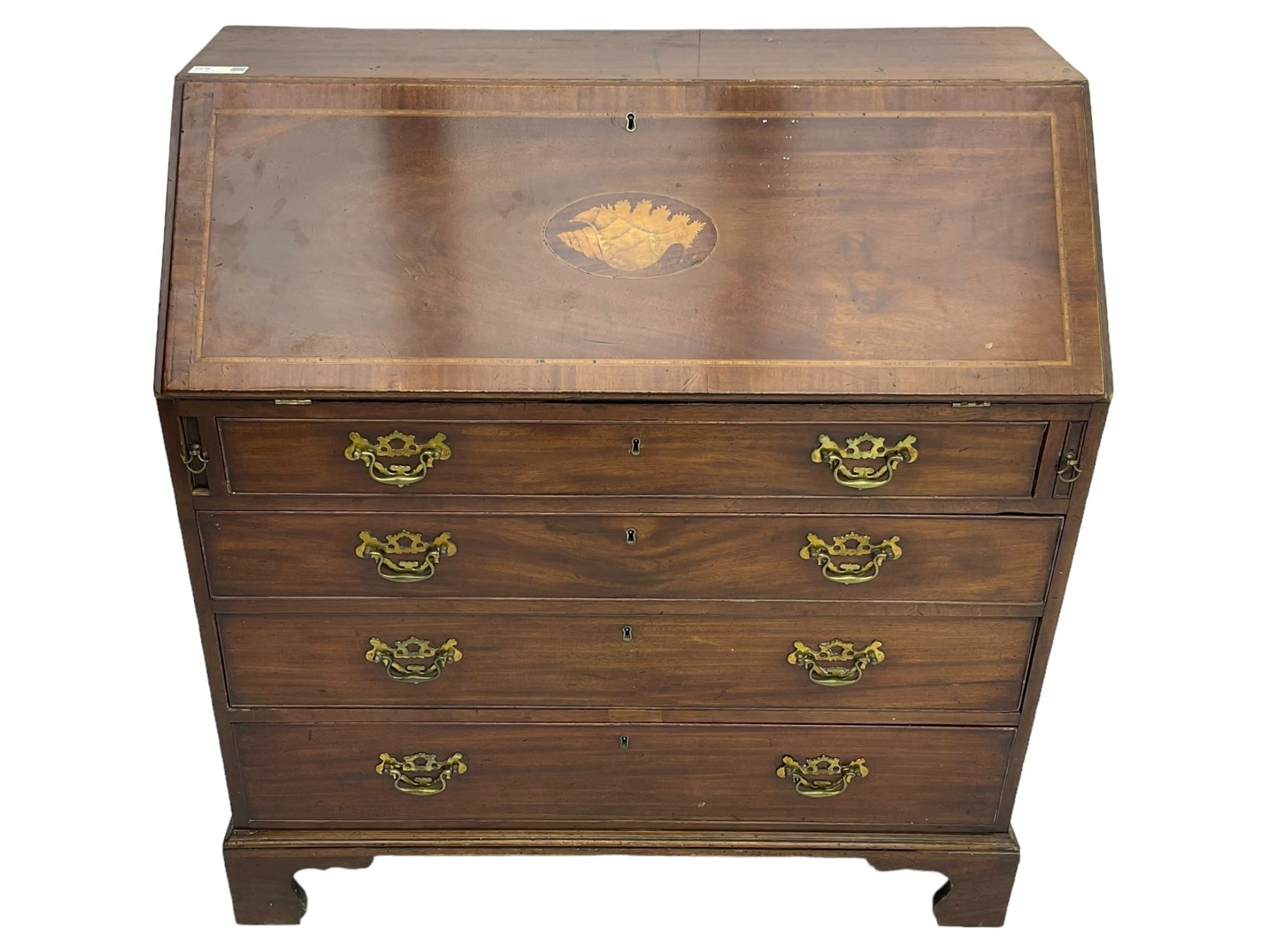 George III mahogany bureau, the conch inlaid fall front enclosing pigeon holes, shelves and central cupboard with inlaid flower motif, four graduating cock-beaded drawers below each with brass handles, lower moulded edge over shaped bracket feet