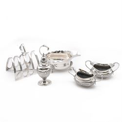 Group of silver, comprising 1930s five bar toast rack, hallmarked B & W Ltd, Birmingham 1931, three piece Edwardian silver cruet set comprising two open salts and a pepper shaker, hallmarked E J Trevitt & Sons, Chester 1904 and a small 1930s silver sauce boat, hallmarked Edward Barnard & Sons Ltd, London 1937 