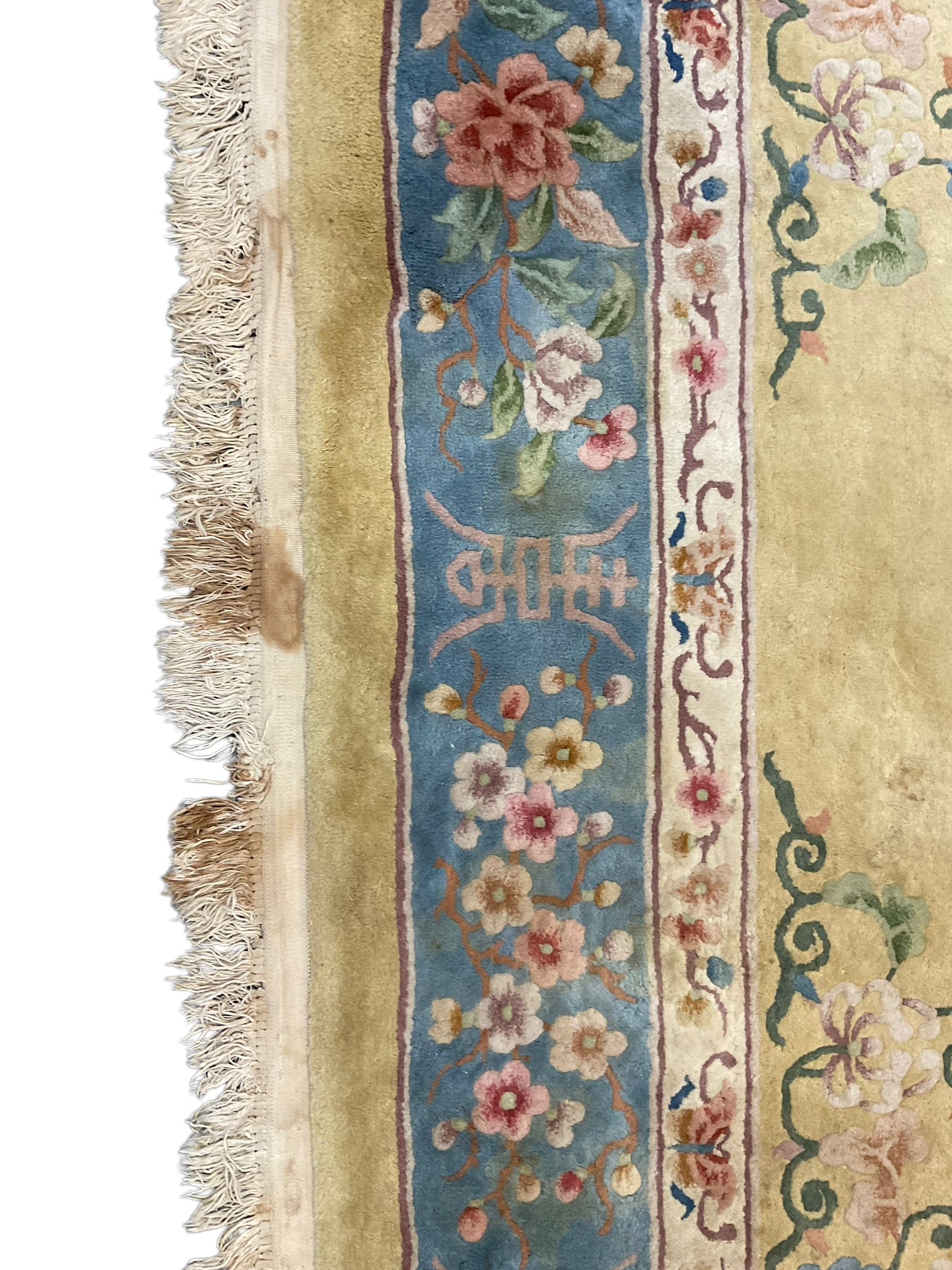 Large Chinese washed woollen carpet, pale sage green ground and decorated with flowers