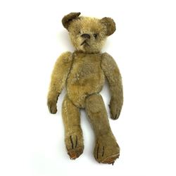 Early 20th century American mohair teddy bear c1920 with wood wool filled body humped back body with jointed limbs, black boot button eyes and horizontal stitched nose and mouth H12