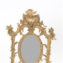 Rococo style cast gilt metal table mirror, the oval mirror plate within an open C scroll and foliate detailed frame, with easel style support verso, H33cm, together with a pair of cast gilt metal acanthus surround frames, H28.5cm