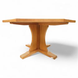 Mouseman - adzed oak octagonal concave dining table, raised on cruciform base, the supports and sledge feet also adzed, carved with fat mouse signature, by the workshop of Robert Thompson, Kilburn