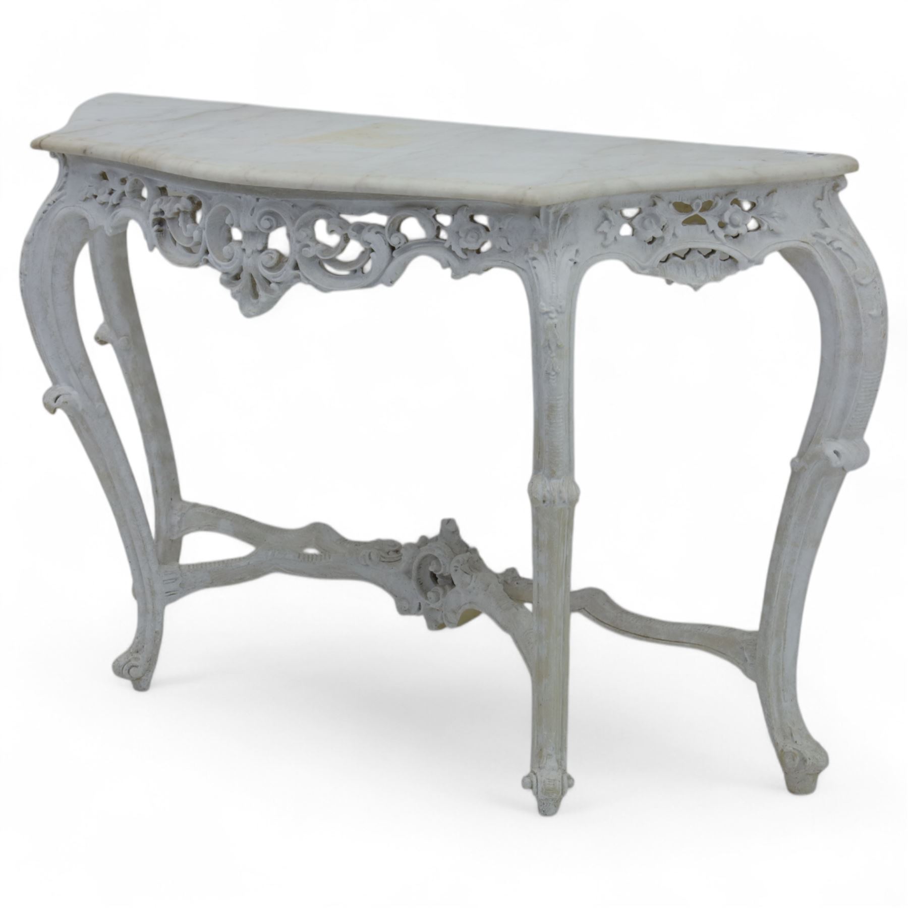 Early 20th-century Rococo revival-style console table, white serpentine-shaped marble top with moulded edge, frieze with openwork scrolling foliage, rocaille shells and deep apron, stretcher with central carved cartouche with shell and foliate motifs, supported on four cabriole legs, knees carved with acanthus leaf and terminating in scroll feet 