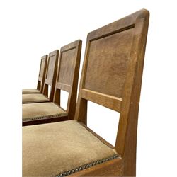 'Eagleman' set four oak dining chairs, adzed panelled backs, upholstered seats with stud work band, the side rails relief carved with inset eagle signature, shaped octagonal supports joined by stretchers, by Albert Jeffray of Sessay, Thirsk