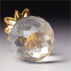 Pair of Swarovski Crystal candlesticks, boxed, together with two paperweights in the form of pineapples with gilt mounts, a large and small example, boxed (4)