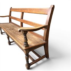 Early 20th century pine and oak bench seat, stained pine rail back frame with shaped oak arms
