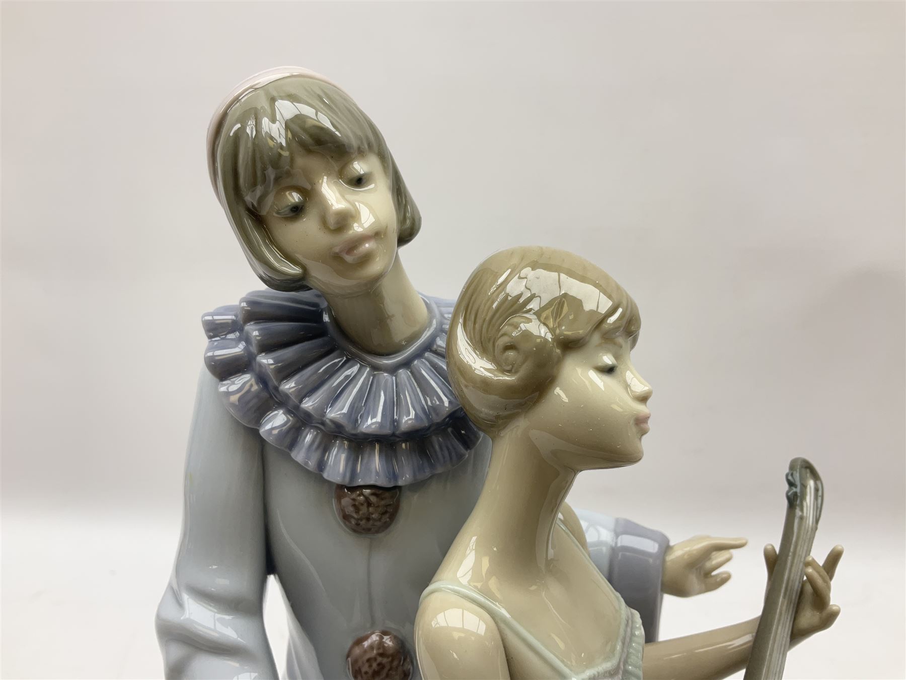 Lladro figure, Minstrel's Love, modelled as a couple entertaining, the lady in ballerina costume playing the lute and the gent stood behind her in jester type dress, sculpted by Rafael Lozano, with original box, no 5821, year issued 1991, year retired 1993, H31cm