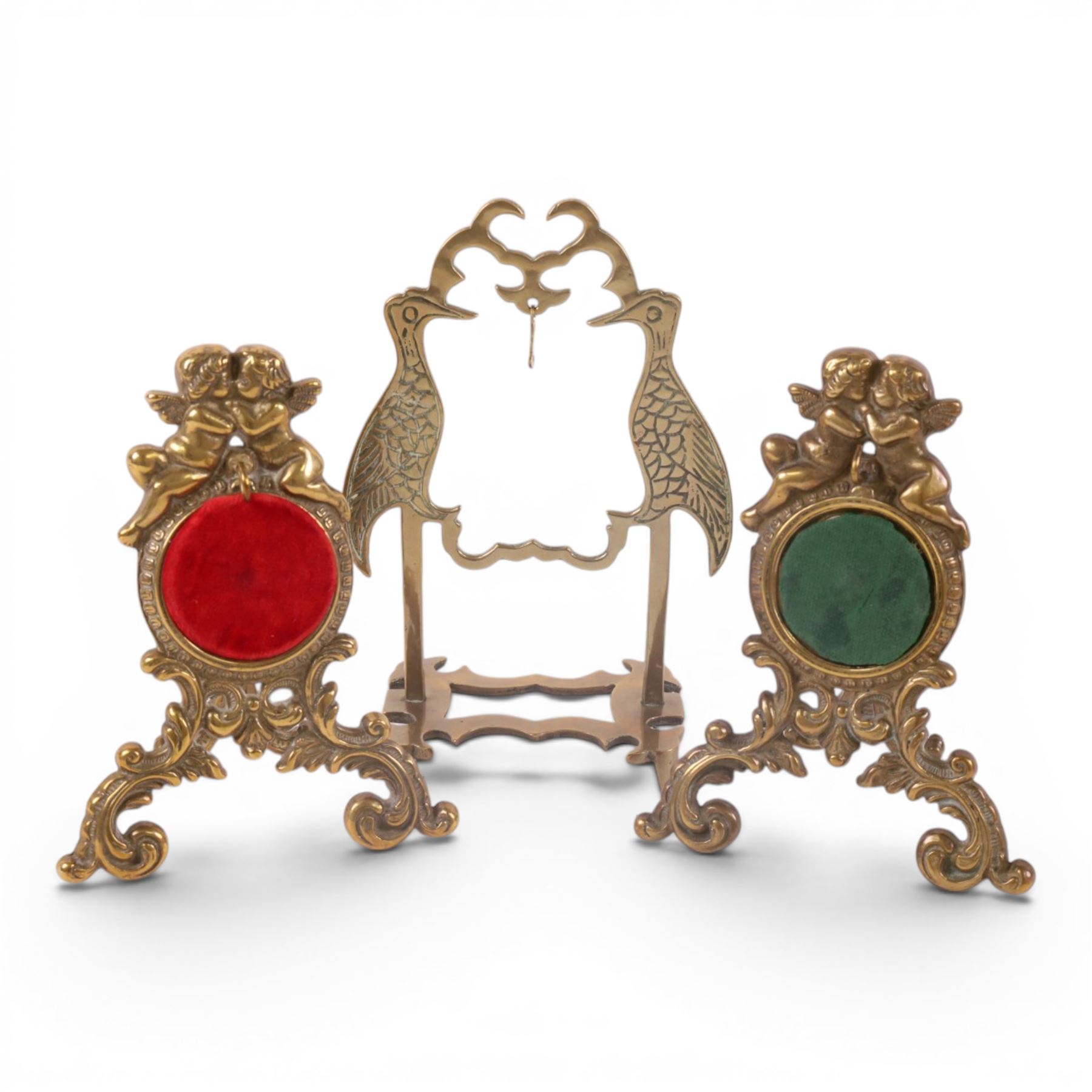 Collection of brass watch stands, including an example modelled as a cherub upon an onyx base, tallest H17cm  