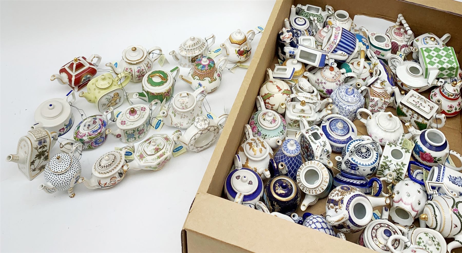 A large collection of miniature teapots, mostly by Porcelain Art. 