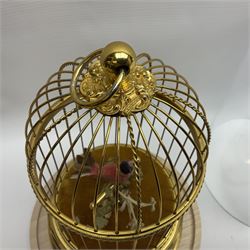 Swiss Reuge Music bird cage automaton music box, the bird with articulated head and beak, in a gilt brass cage, with a glass dome and stand, H30cm