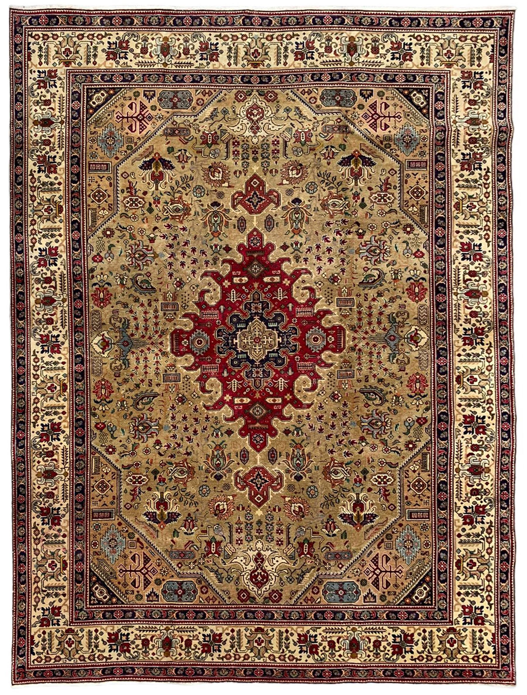Persian Azarbaijan golden ground carpet, the shaped crimson ground medallion decorated with geometric motifs, the field profusely decorated with stylised plant and flower head motifs, repeating border with guard bands 
