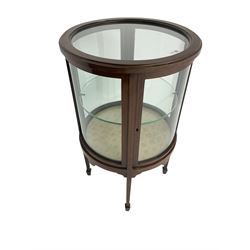 Edwardian inlaid mahogany drum shaped vitrine or bijouterie table with glass top and sides and single door with central glass shelf, on four tapering square legs with spade feet