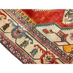 Anatolian Turkish ivory ground carpet, the central geometric pole medallion within an amber field, the guarded border decorated with stylised plant motifs surrounded by bands of repeating flower heads