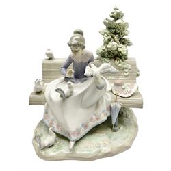 Lladro figure, Feeding the Pigeons, modelled as a woman feeding pigeons on a bench, sculpted by Regino Torrijos, with original box, no 5428, year issued 1987, year retired 1989, H23cm 