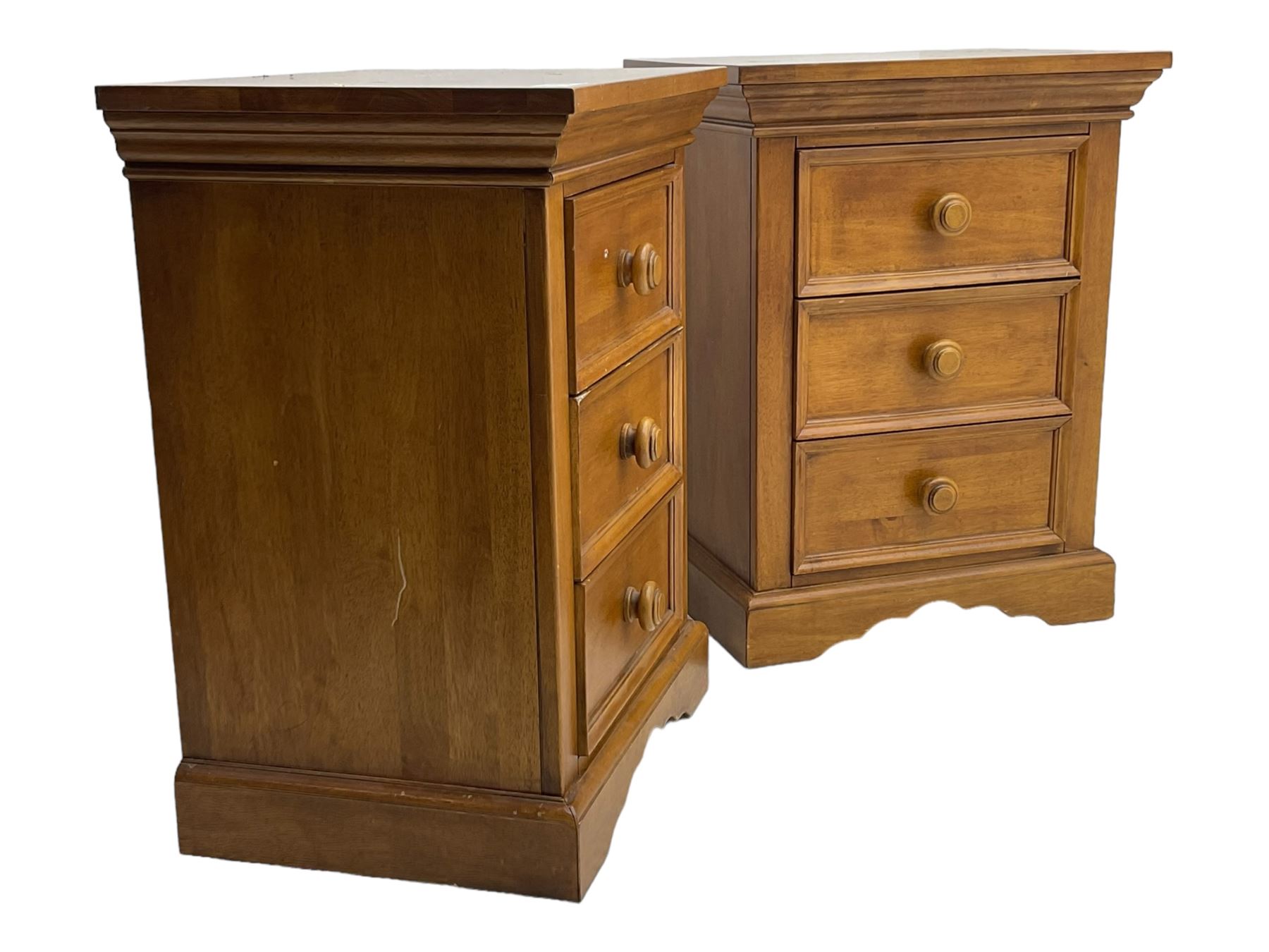 Pair of contemporary cherry wood bedside chests, rectangular top and projecting moulded cornice over three drawers, on plinth base with shaped apron