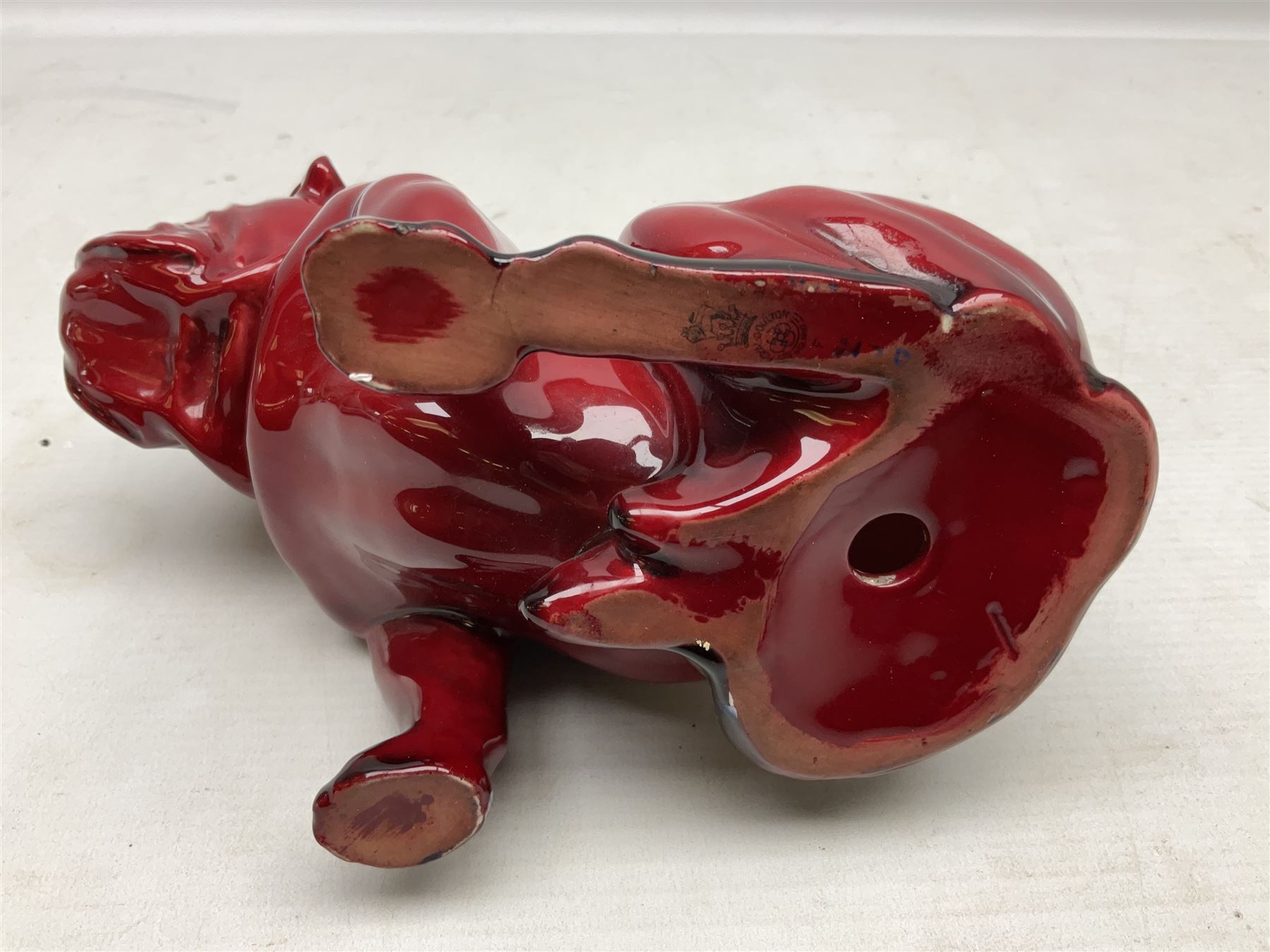 Royal Doulton Flambe figure of a Bulldog, modelled seated, model no 135, with printed maker's mark and K and impressed 135 beneath, H13.5cm