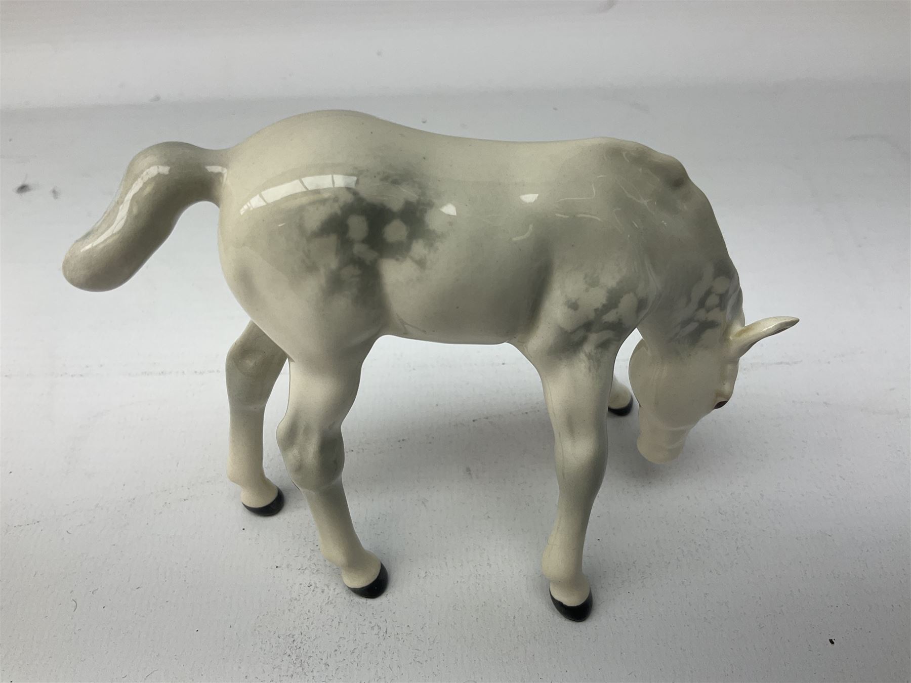 Collection of Beswick horses, including grey horse no.701, palomino foal no 836, grey stocky jogging mare no.855 etc, together two Royal Doulton horses, (8)