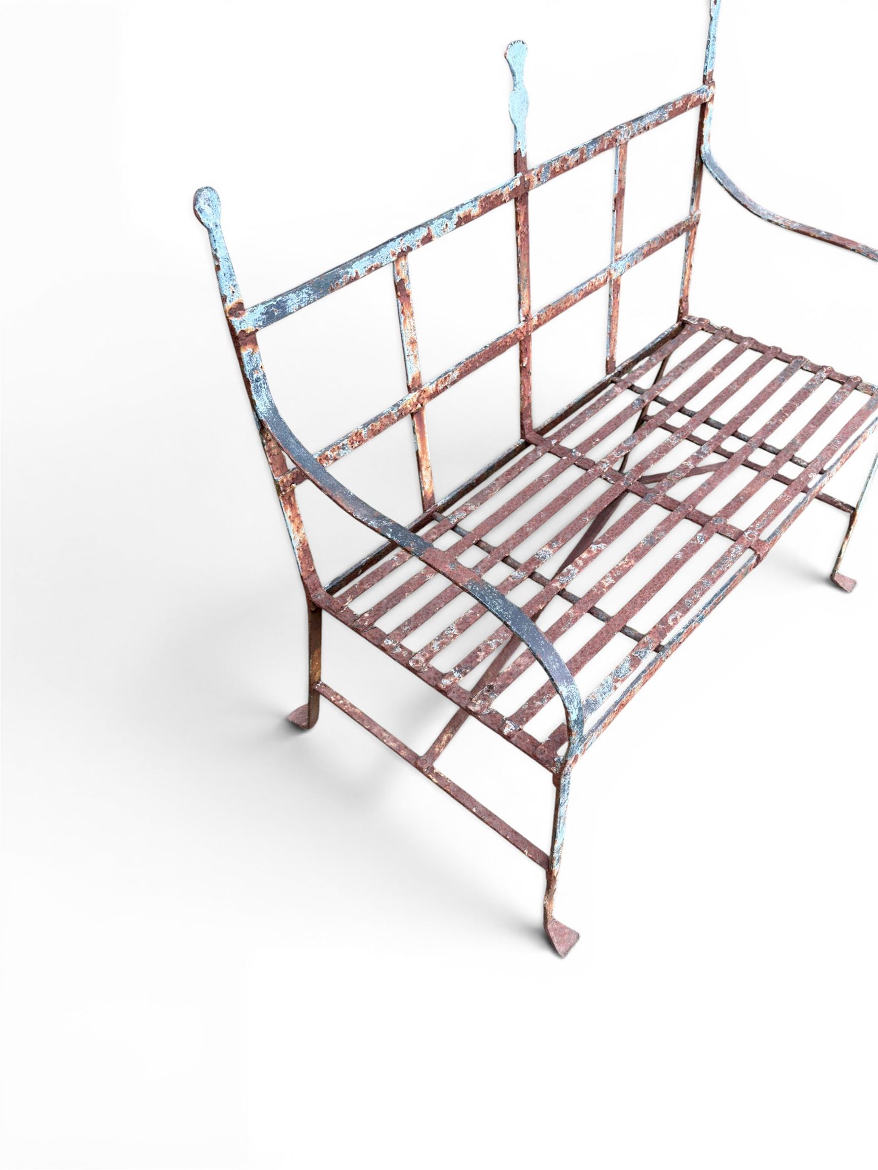 Regency period wrought iron strapwork garden bench, cresting rail with central Scottish thistle motif and flanking pediments, in distressed blue painted finish