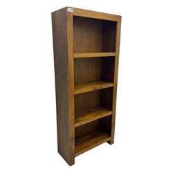 Contemporary Dakota mango wood open bookcase, rectangular form with four fixed open shelves, raised on stile supports