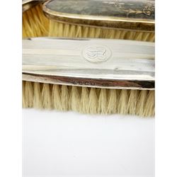 A silver mounted faux tortoiseshell dressing table set, comprising hand held mirror, two hair brushes, and two clothes brushes, each with inlaid swag to the back, hallmarked Lionel Smith & Co, Birmingham 1927, plus a silver mounted clothes brush with engine turned decoration and monogramed plaque, hallmarked William Neale & Son Ltd, Birmingham 1929, pair of silver plate on copper bottle coasters, cased set of fish servers, and cased set of fish eaters and servers, the knife blades marked Mappin & Webb. 