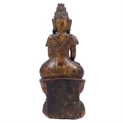 Late 18th century, carved wooden buddha, seated cross legged on a lotus base, with traces of original painted decoration, H35cm 