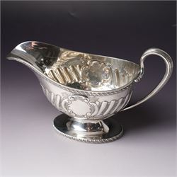 Victorian silver sauce boat engraved with a monogram Sheffield 1892 Maker John Round  & Son Ltd, another with crimped rim Birmingham 1912 Maker Elkington & Co, two silver pepperettes and a small silver challenge cup