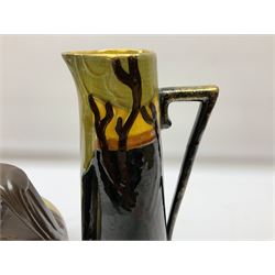 T. Forester Phoenix ware ewer of tapering form decorated with peacock and Bretby twin handled vase decorated with figures fishing in a boat sea scene