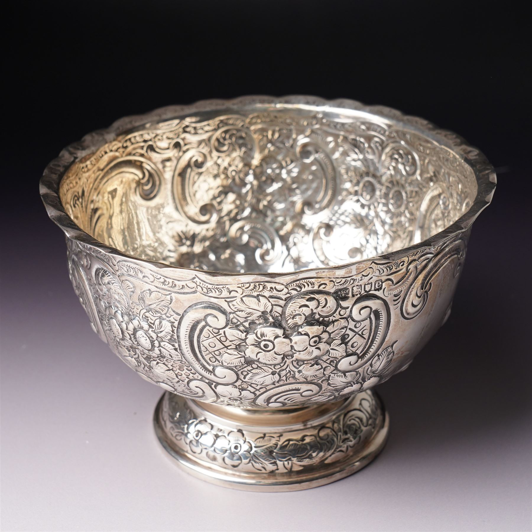 Late Victorian silver bowl embossed with flower heads and scrolls and with vacant cartouches on short pedestal foot D17cm London 1900 Maker Goldsmiths & Silversmiths Company