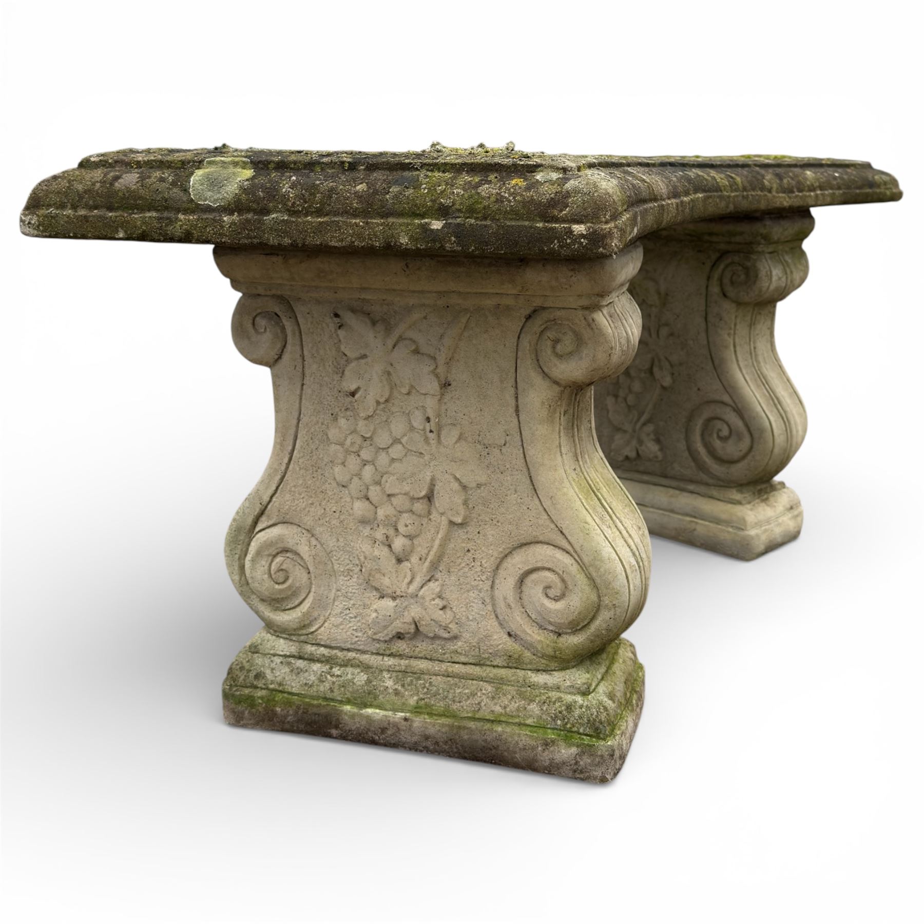 Composition stone garden bench with scroll supports
