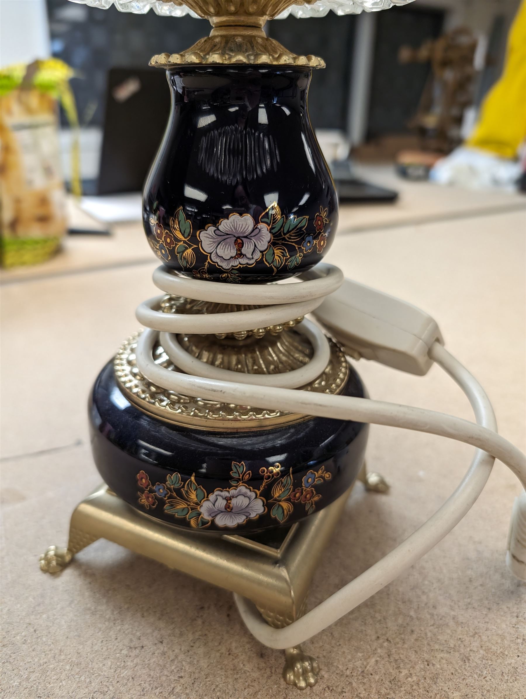 Ceramic table lamp, decorated with florals on a blue ground, with frosted glass shade with glass droplets, with two pin plug
