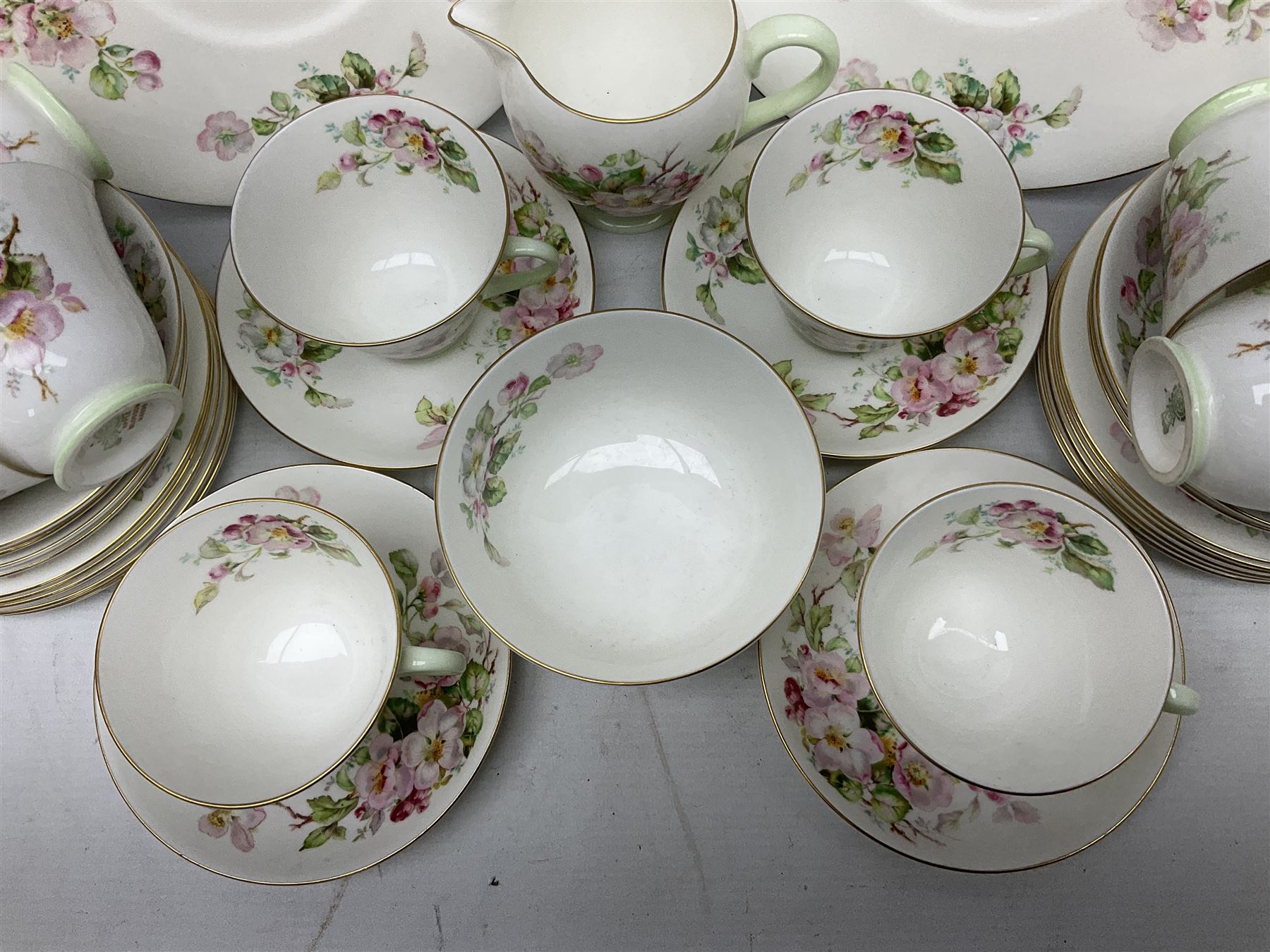 Royal Doulton Apple Blossom pattern tea service for twelve, comprising twelve saucers, twelve tea plates, twelve teacups, milk jug, sucrier and two cake plates