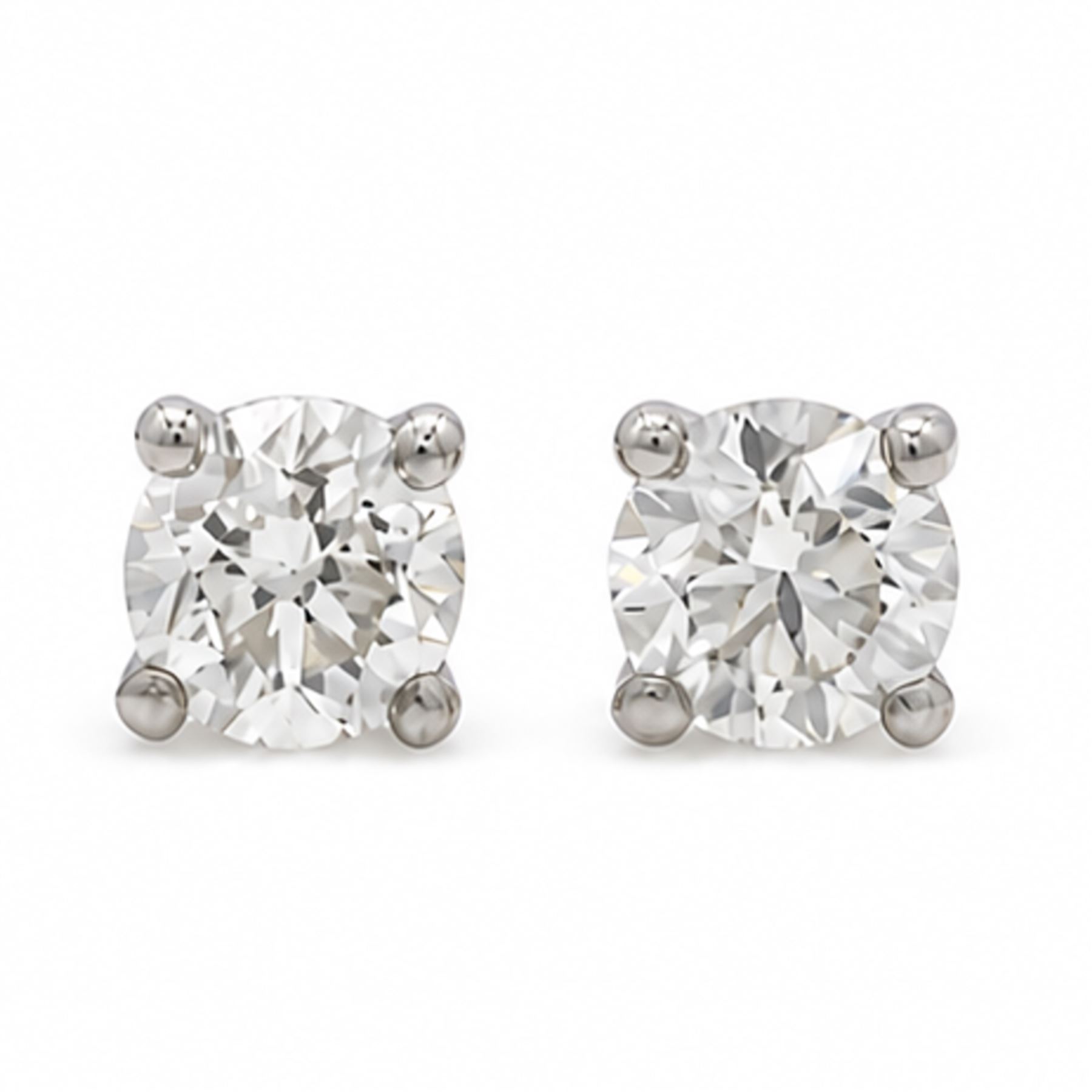 Pair of platinum diamond earrings, each stud set with a single round brilliant cut diamond, stamped PT 950total diamond weight approx 1.05 carat