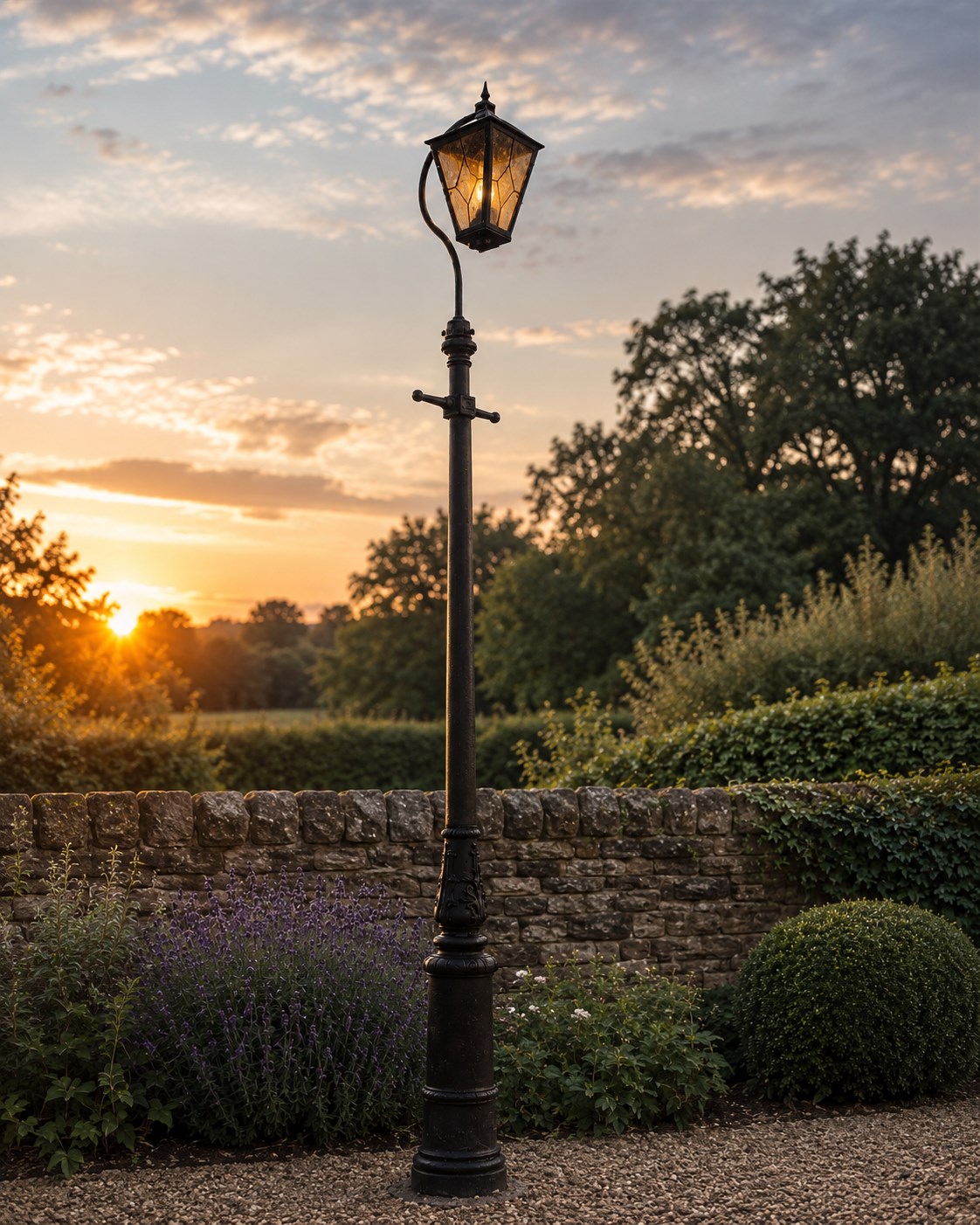 REVO Electric Co. Ltd., Tipton - early 20th century cast iron street lamp standard, the later hexagonal lantern with amber leaded glazing and pointed finial, supported on a swan-neck bracket above a ring-turned capital, tapering column and ladder rest, terminating in a moulded scrolling foliate-decorated base with lappet collar, stamped REVO

Provenance: formerly installed as street lighting in Prestwich, Greater Manchester