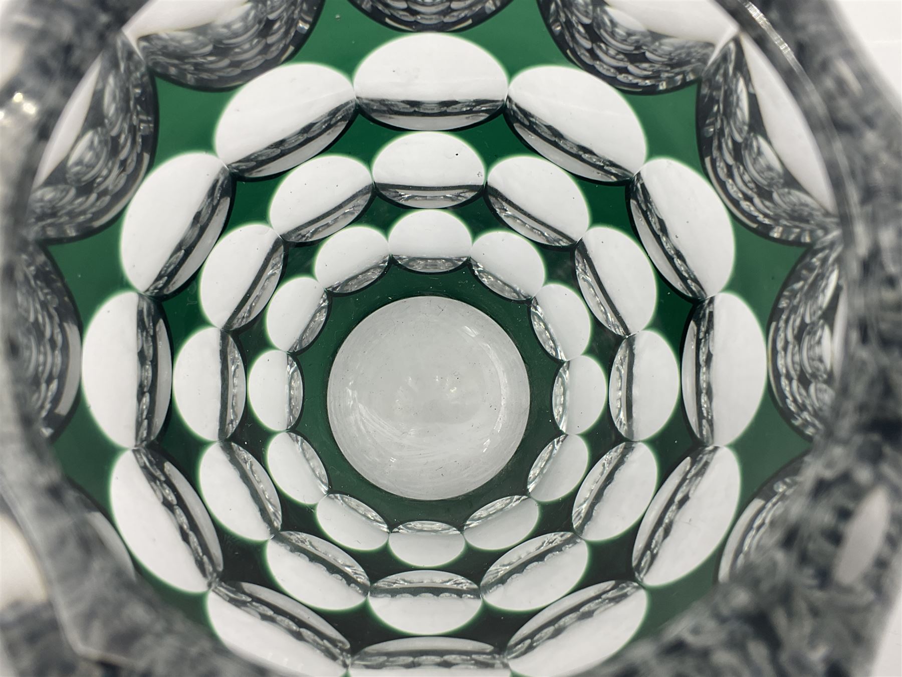Val St Lambert style glass vase of shouldered ovoid form, cased in deep green over clear and heavily cut with repeat spherical pattern, indistinctly signed beneath ('Jac E. Dalmley'?), H15cm