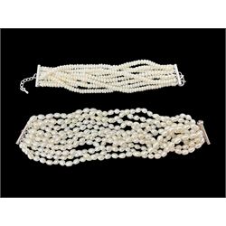 Two fresh water pearl bracelets, including a twelve strand example and a smaller eight strand example, each with silver clasps
