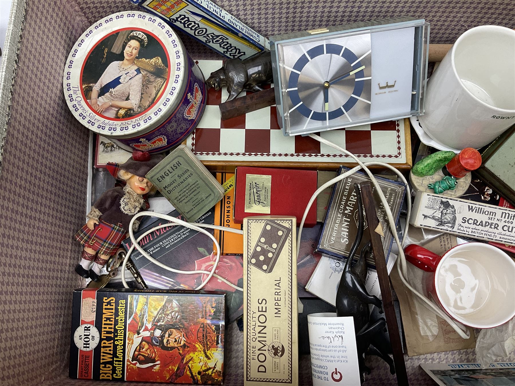 Ukelele, Westclox electric alarm  clock, vintage tins, National Rail hat, ceramics, boxed games, carved wood figures etc all housed in a suitcase