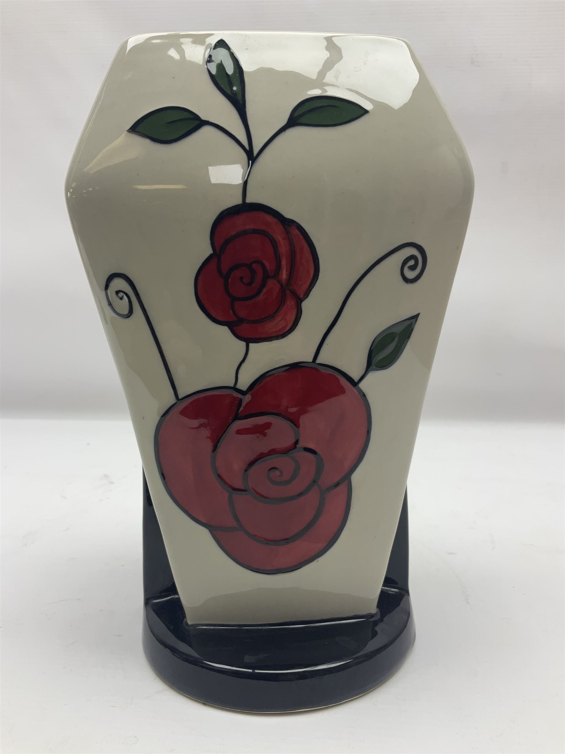 Charlotte Rhead for Crown Ducal ceramics, comprising coffin shaped vase depicting a woman in 1920s dress, a vase with handle, decorated with autumn leaves and a bowl, decorated with flowers and berries, with printed and signed marks beneath, coffin vase H24cm