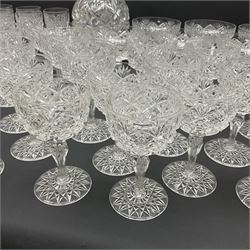 Early 20th century cut glass decanter, the body decorated with hobnail, star and fan cut decoration, with faceted neck and matching stopper, together with a collection of matching glasses, all with similar cut decoration, including sherry glasses, champagne coupes and wine glasses (43), decanter H34cm
