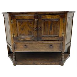 Traditional oak shaped front side cabinet, fitted with two cupboards and single drawer