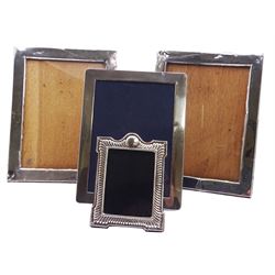 Four silver mounted photograph frames, comprising pair of mid 20th century examples of plain rectangular form, hallmarked W I Broadway & Co, Birmingham 1942, overall H25cm W19.5cm aperture H20.5cm W14.5cm, a smaller modern examples of similar form, hallmarked Kitney & Co, London 1994, overall H21cm W16cm aperture H17.5cm W12.5cm, and a smaller modern Britannia standard example with fluted decoration, hallmarked London 2020, makers mark P V W, also marked 999, overall H13cm W9.5cm aperture H8.5cm W6.5cm, each with easel style support verso