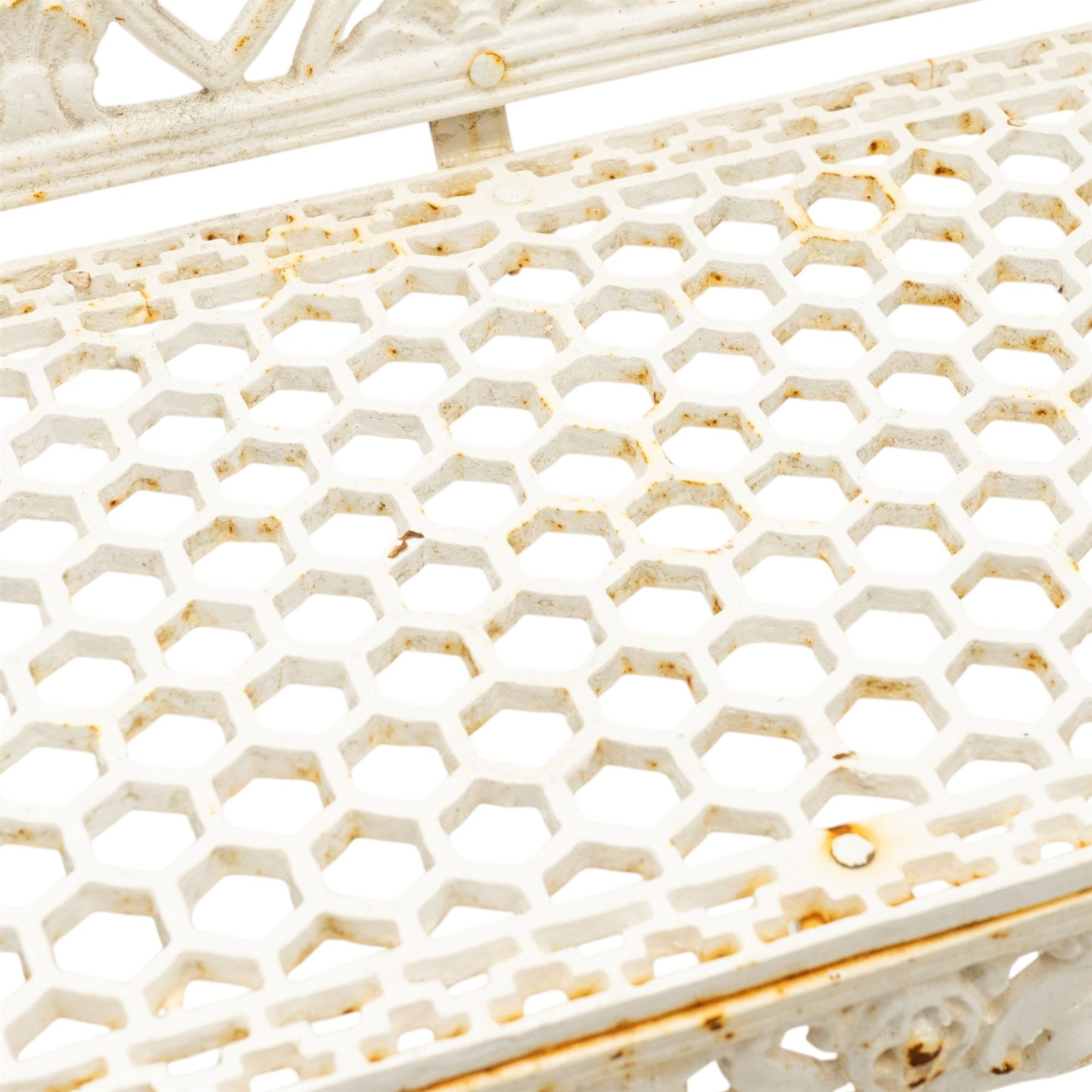 Victorian revival heavy cast iron garden bench, ornate back rest with scrolls, floral motifs and central crest, pierced lattice seat, curved arms and decorative legs, painted in antique white, in the Gothic Coalbrookdale style